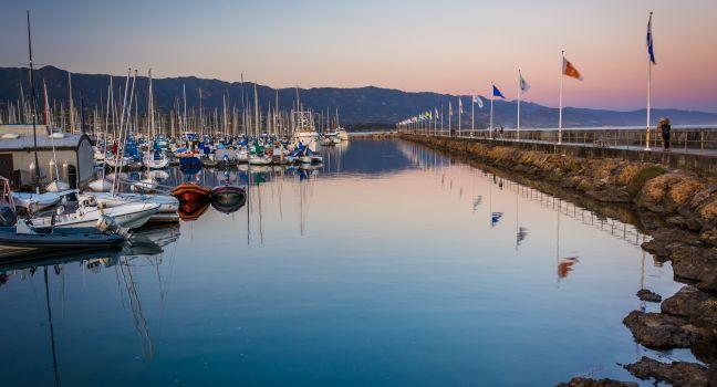 Breakwater and boats at the harbor at sunset, in Santa Barbara, California.