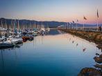 Breakwater and boats at the harbor at sunset, in Santa Barbara, California.