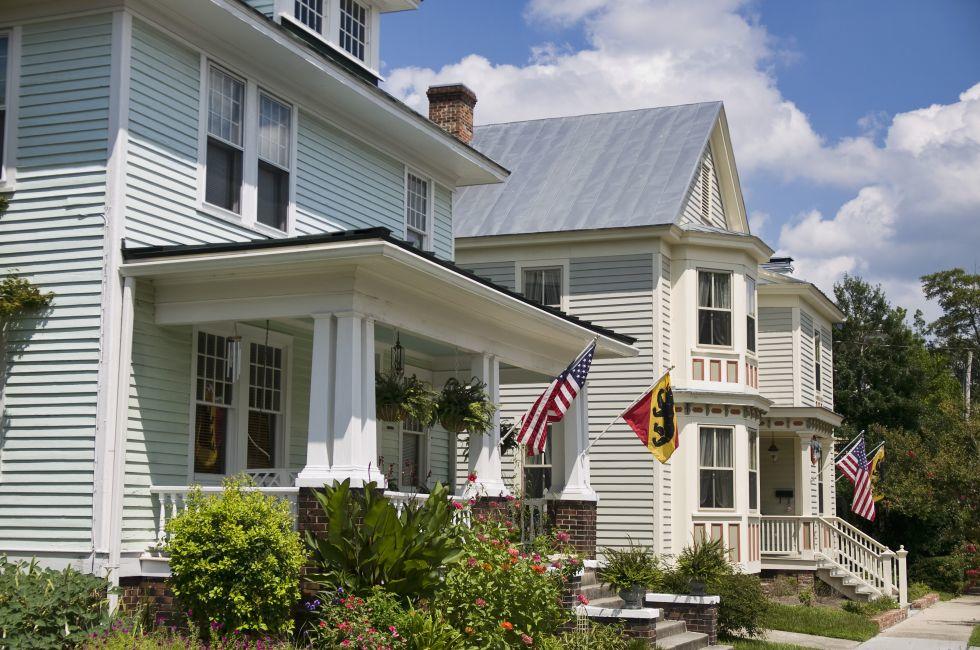 Vintage homes in New Bern North Carolina flying the American Flags and the flags of the town of New Bern.