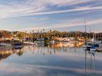 Sunrise at residential development by water in Ventura California with modern homes and yachts boats
