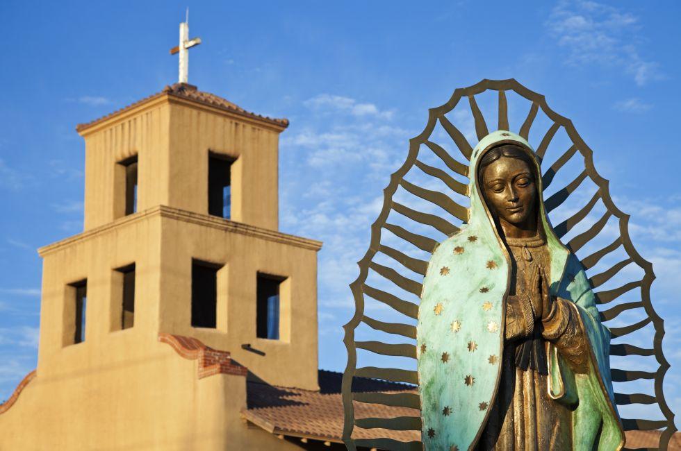 Mary Of Guadalupe in front of Sanctuary Of Guadalupe, Santa Fe, New Mexico.