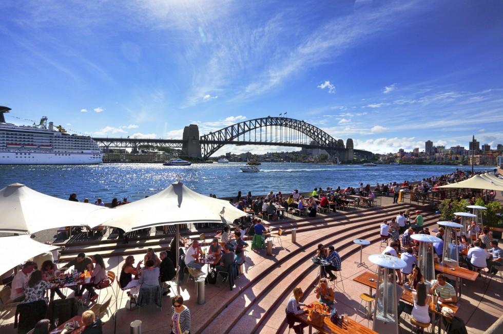 SYDNEY AUSTRALIA - SEPTEMBER 15, 2013: Residents and visitors dine, relax and basque in the glorious afternoon sun quayside by the harbour, Sydney Australia.  ;