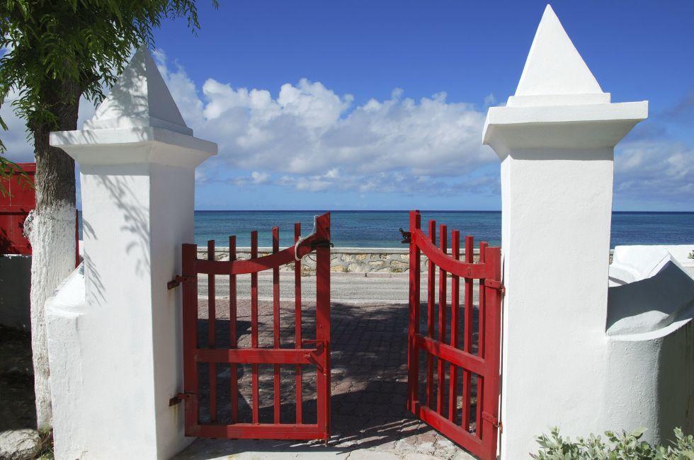 The red gates of the cathedral that leads to the sea in Cockburn town on Grand Turk island (Turks & Caicos).