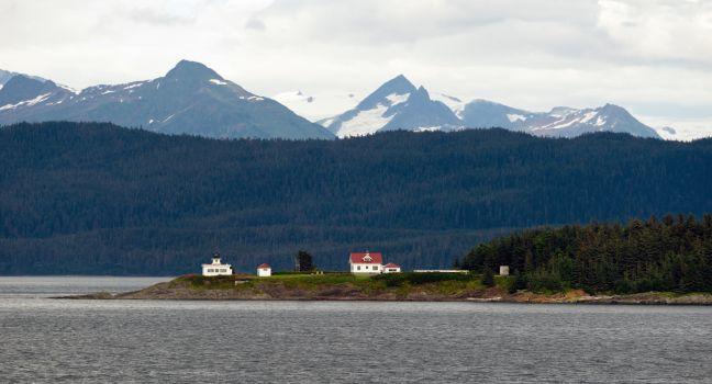A marine highway ferry boat passes a nautical beacon on the inside passage.