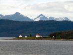 A marine highway ferry boat passes a nautical beacon on the inside passage.