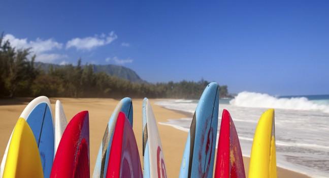 Tips of surfboards at Lumahai beach in Kauai Hawaii on a sandy shore by the ocean.