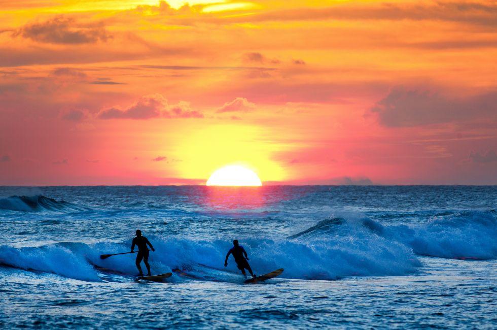 Sunset Surfer at sunset on Resort Beach of Kauai Hawaii