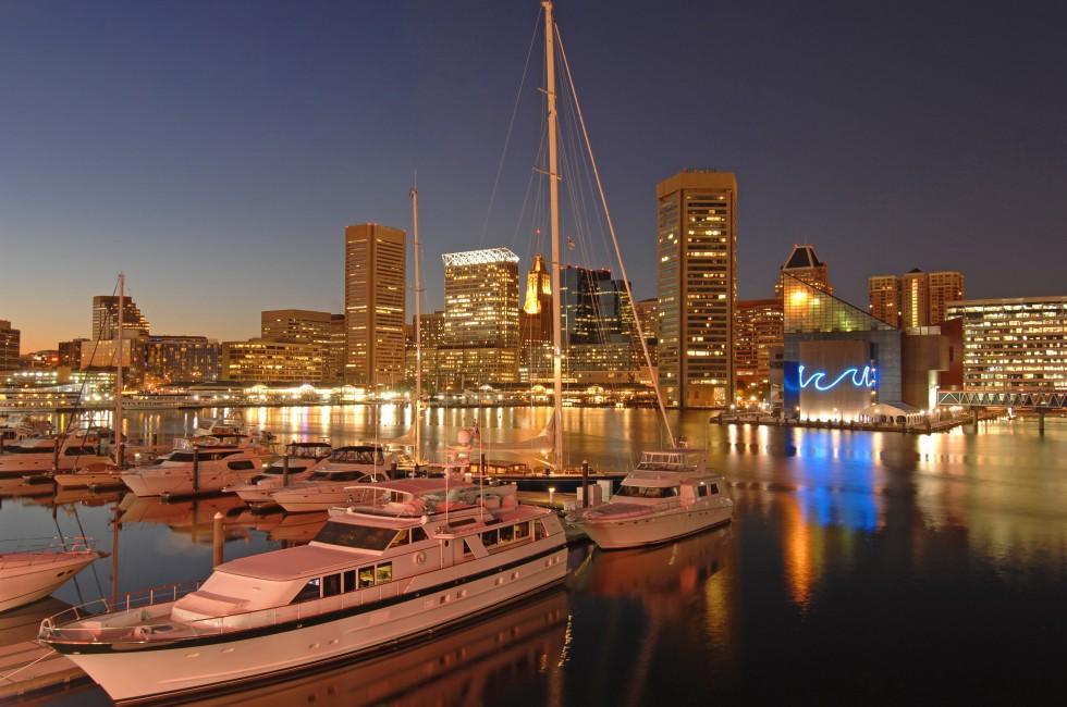 foreground of yachts with the Baltimore skyline at dusk behind