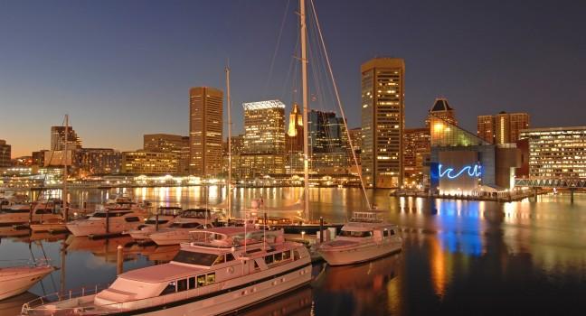 foreground of yachts with the Baltimore skyline at dusk behind