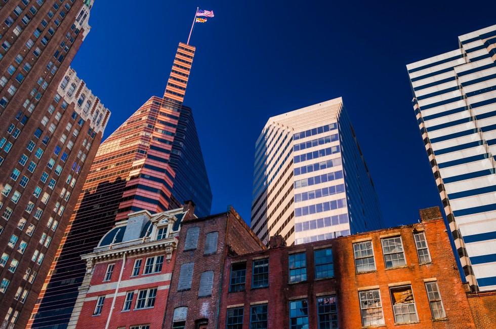 Looking up at a mix of modern and old buildings in Baltimore, Maryland.
