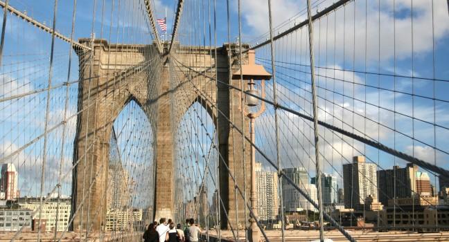Tourists and residents of New York on Brooklyn Bridge