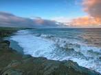 Views of the sea and black lava rocks of recent eruptions of Kilauea from Kalapana for sunset, Puna district, Big island, Hawaii.