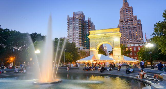 NEW YORK CITY - SEPTEMBER 12, 2012: Crowds gather at Washington Square Park. The historic park is popular in the summer.