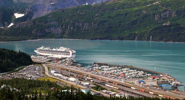 Overlooking Whittier Alaska on a summer day with a large cruise ship in port.