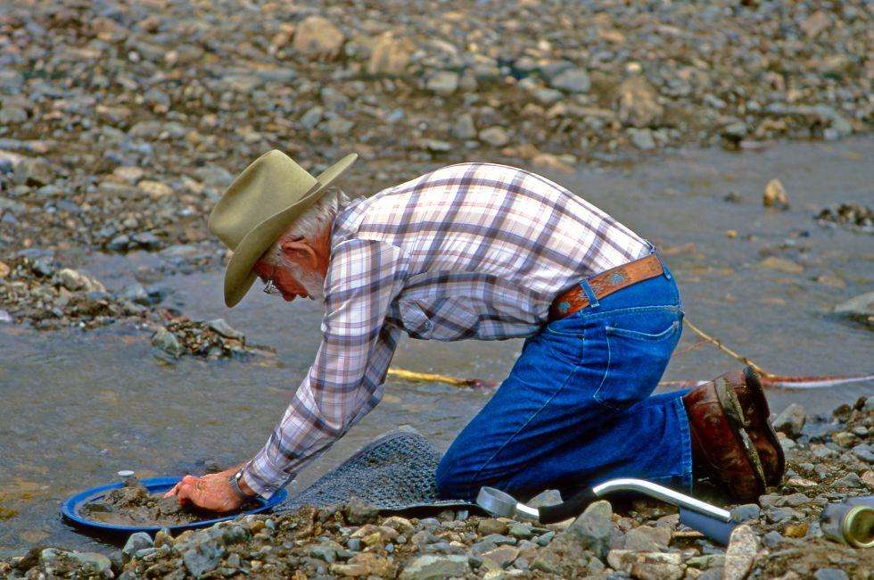 CHICKEN CREEK, ALASKA, USA - JULY 24: Unknown man washing gold in the creek in Chicken Creek on July 24, 1997 in Alaska, USA. 