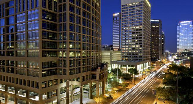 Long exposure photo of the a city street in downtown Phoenix, Arizona at night. 