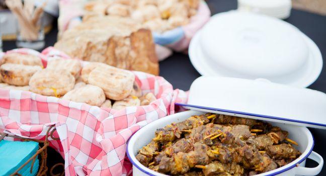 Fresh roasted bread and mutton kebabs in dishes on a table
