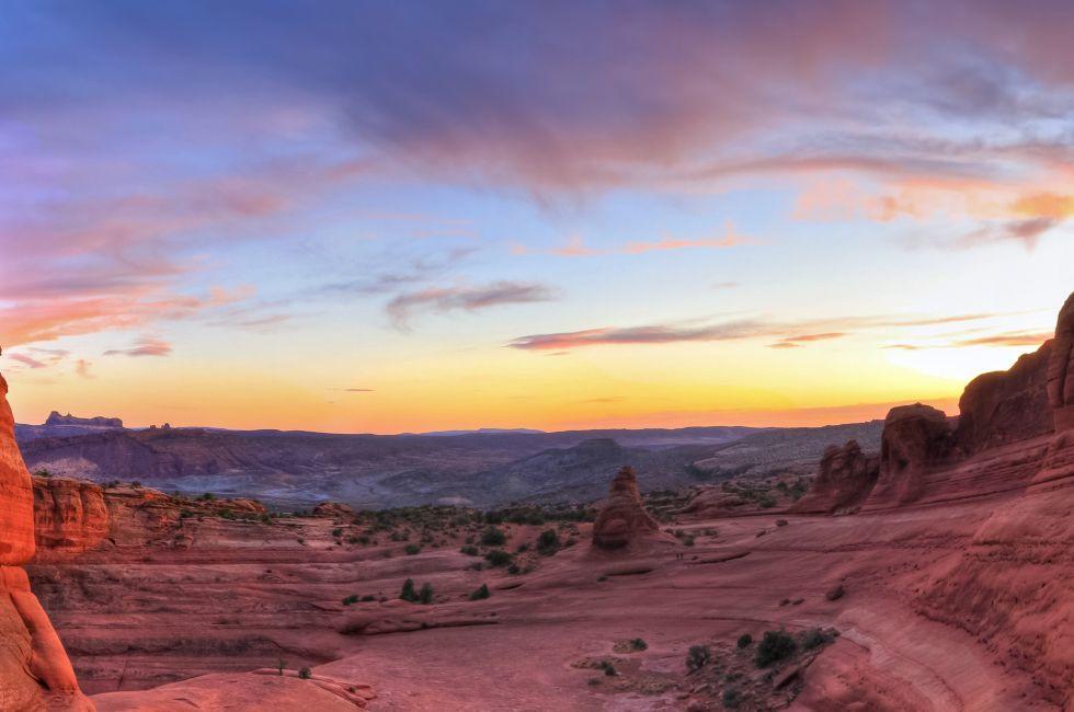 Sweeping sunset panoramic view of famous Delicate Arch in Arches National Park in Moab, Utah (HDR).