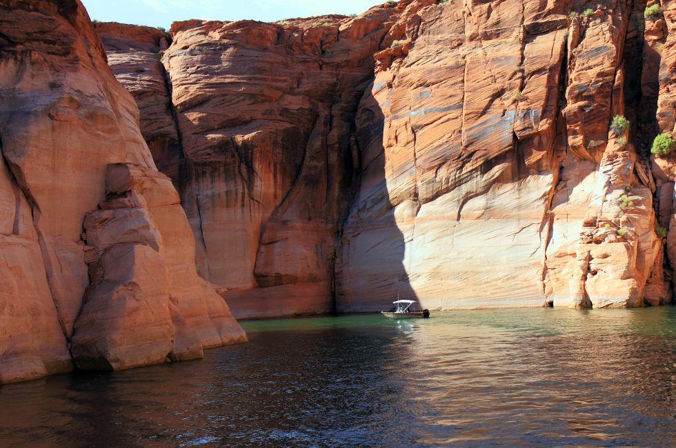 Lake Powell, in Glen Canyon spans 186 miles  in Utah and Arizona.  its coastline is populated with colorful sandstone cliffs,  pristine blue green water, islands, rock formations, resorts and marinas