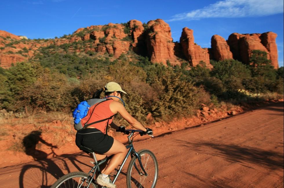 an Asian woman mountain biking along a dirt road near Sedona Arizona; Shutterstock ID 28517962; Project/Title: Fodors; Downloader: Melanie Marin