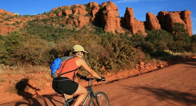 an Asian woman mountain biking along a dirt road near Sedona Arizona; Shutterstock ID 28517962; Project/Title: Fodors; Downloader: Melanie Marin