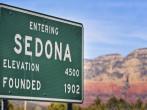 Entering Sedona Arizona, USA, road sign with red rock mountains visible in background.; Shutterstock ID 68866102; Project/Title: Fodors; Downloader: Melanie Marin