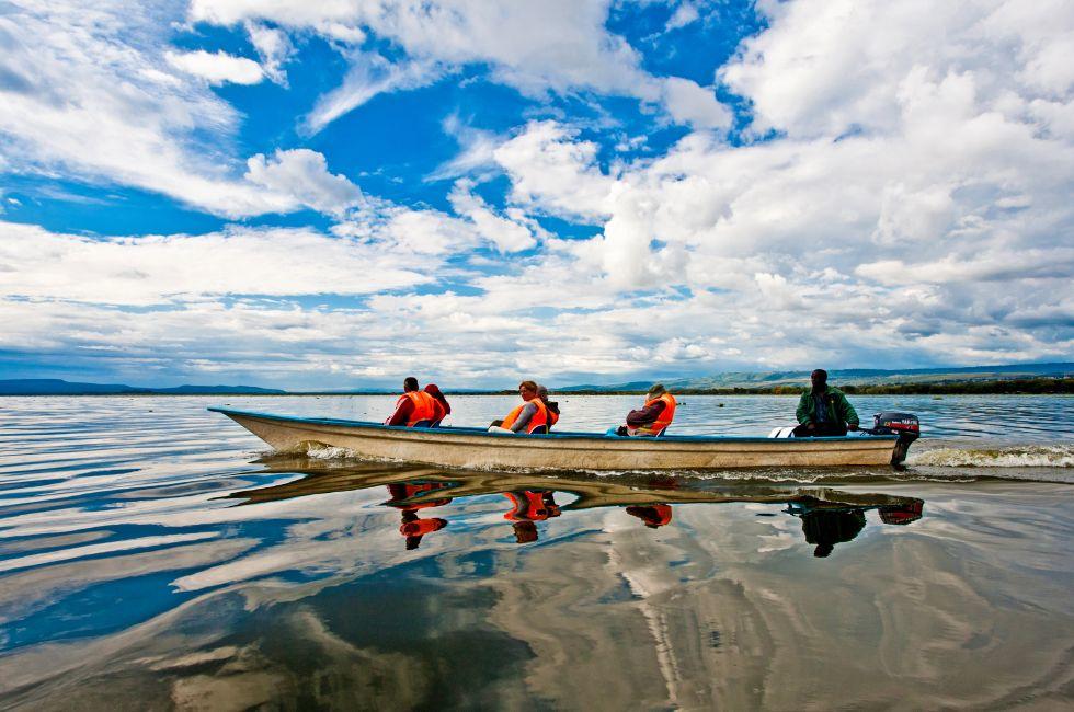 LAKE NAIVASHA, KENYA- OCTOBER 16: Tourists taking a boat trip on October 16, 2012 on Lake Naivasha, Kenya. Lake Naivasha is popular with both foreign and domestic tourists.