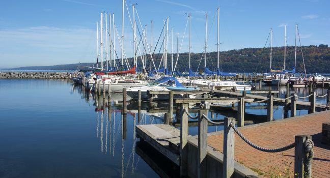 Sail boats at the boat marina at the southern end of Seneca lake in Watkins Glen New York on a beautiful blue sky day in autumn.