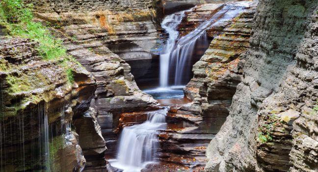 Watkins Glen waterfall in woods with rocks and stream in Watkins Glen state park in New York State