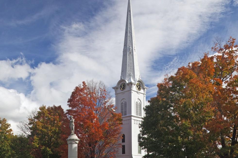 Autumnal shot of the main street of Manchester Vermont in fall as the bright trees turn orange and red.