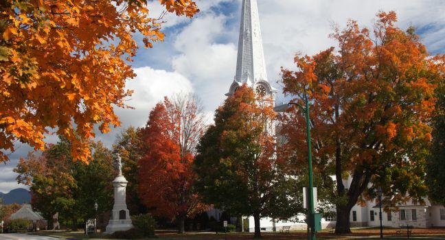 Autumnal shot of the main street of Manchester Vermont in fall as the bright trees turn orange and red
