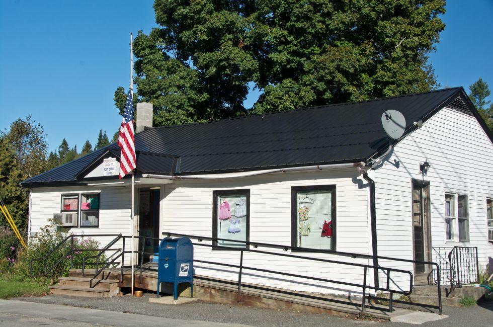 Greensboro, Vermont, USA - September 18, 2013: The flag flies at half-mast outside the Greensboro, VT post office commemorating 9/11.