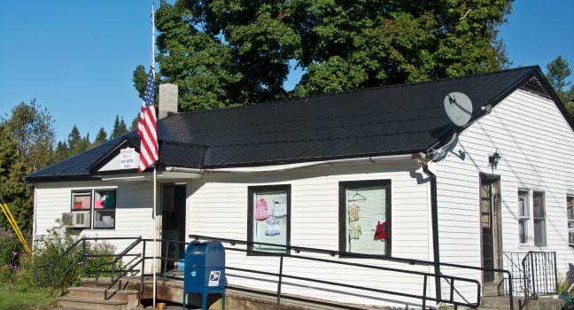 Greensboro, Vermont, USA - September 18, 2013: The flag flies at half-mast outside the Greensboro, VT post office commemorating 9/11.