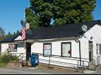 Greensboro, Vermont, USA - September 18, 2013: The flag flies at half-mast outside the Greensboro, VT post office commemorating 9/11.