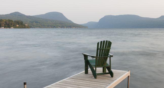 An adirondack chair on a dock at Lake Willoughby, Vermont, USA