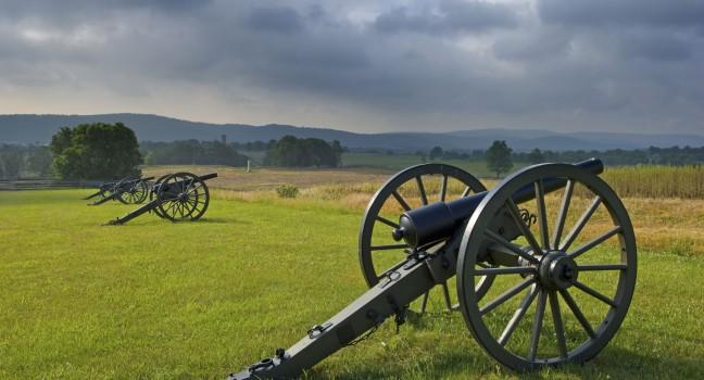Morning storm clouds over a row of cannon at Antietam Battlefield at Sharpsburg, Maryland, USA.
