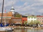 ANNAPOLIS, MARYLAND, USA - APRIL 12, 2013: Tourists shop along the waterfront in historic downtown Annapolis, Maryland, USA, the state capital, dome visible in the background, on April 12, 2013.