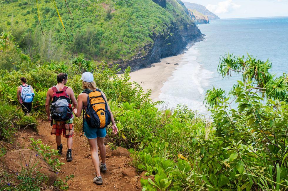Hikers on the famous Kalalau Trail on the north shore of Kauai. The 11-mile trail that leads from Ke'e Beach to Kalalau Beach on the Na Pali coast.