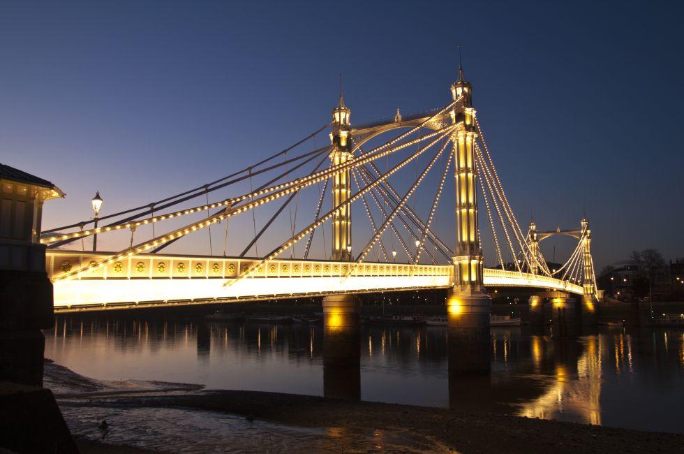 Albert Bridge is a listed road bridge over the River Thames in West London, UK connecting Chelsea on the north bank to Battersea on the south bank. Taken in the early evening.