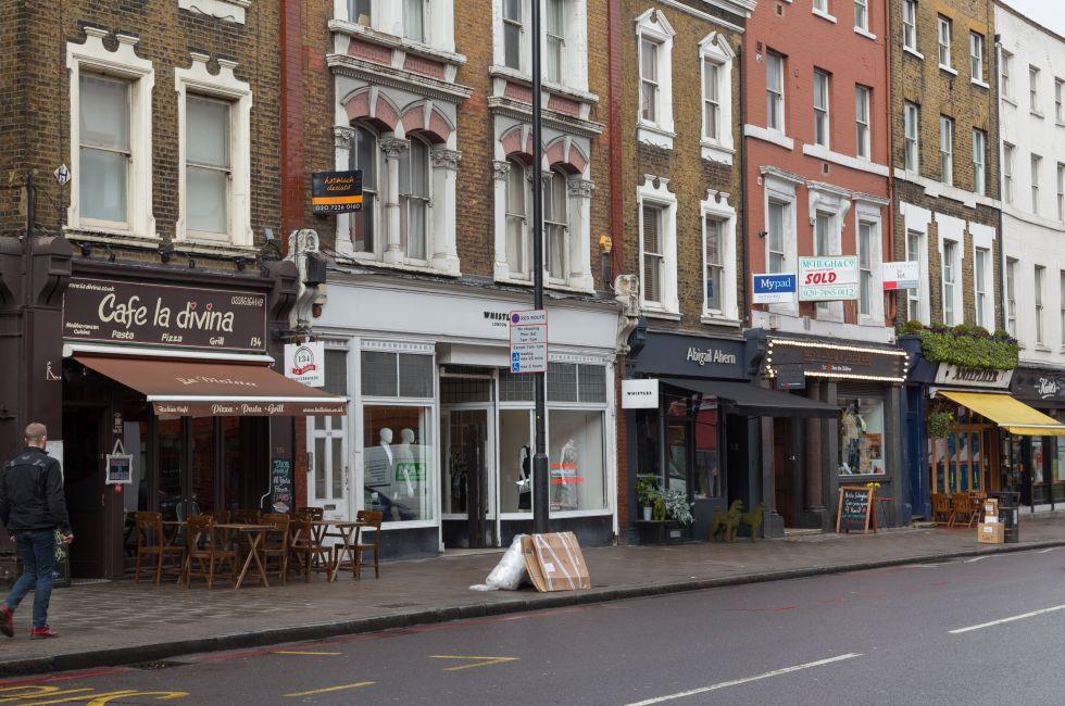 LONDON, UK - 26TH MARCH 2015: A view of various restaurants and businesses along Upper Street in Islington, london. People can be seen.