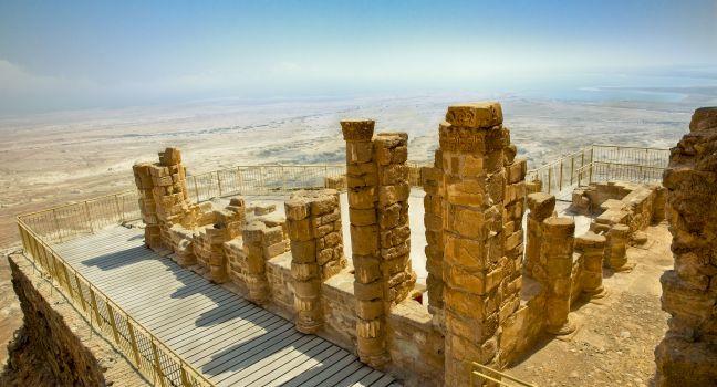 Ruins of ancient fortress Masada. Dead Sea is at background. Masada is the name for ancient palaces and fortifications in the South District of Israel on top of an isolated rock plateau. Israel; 