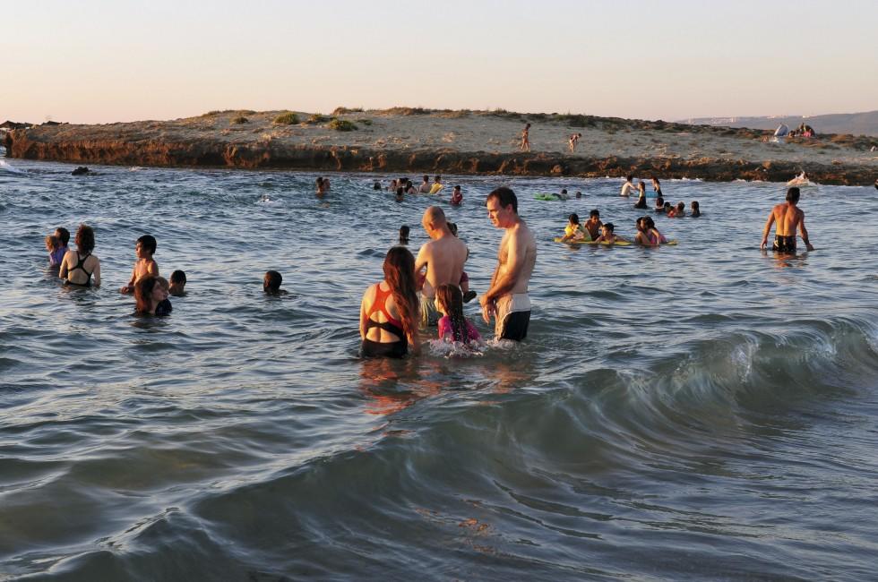 ZICHRON YAAKOV, ISR - AUG 07: Visitors at sanctuary Dor Habonim beach on Au 07 2009. It's one of the top 10 most beautiful beaches in Israel!