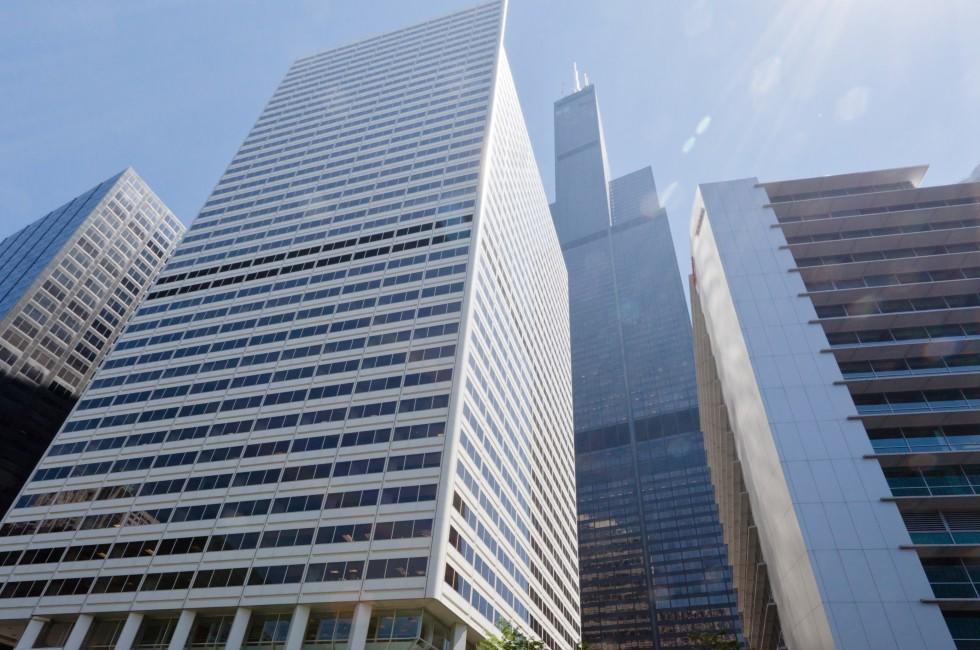 The Willis Tower (formerly Sears Tower) glass windows skyscraper in downtown Chicago, Illinois, United States. The EL mass transport system, pedestrians and cars on the street.