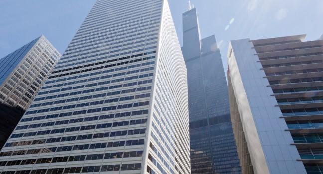 The Willis Tower (formerly Sears Tower) glass windows skyscraper in downtown Chicago, Illinois, United States. The EL mass transport system, pedestrians and cars on the street.