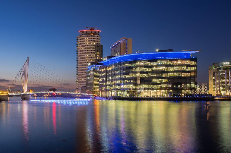 Manchester, UK - March 14, 2015: Salford Quays, Manchester. Night view of the BBC and ITV studio complex at Media City, Salford.