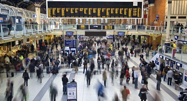 Liverpool street station in the UK at rush hour with all faces blurred out and logos/trademarks removed