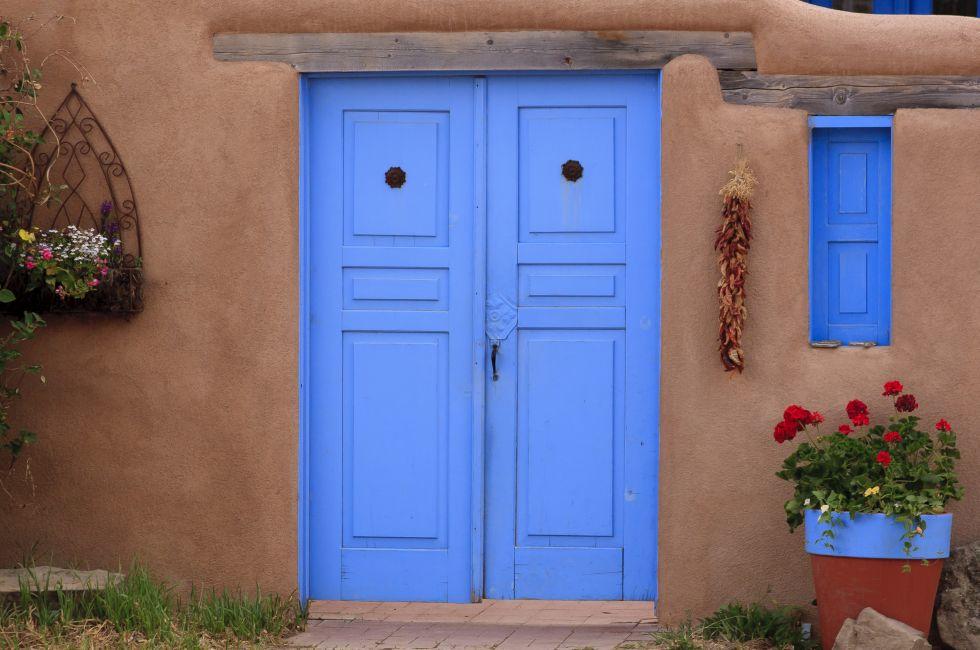 Adobe building and blue door in Rancho de Taos, NM
