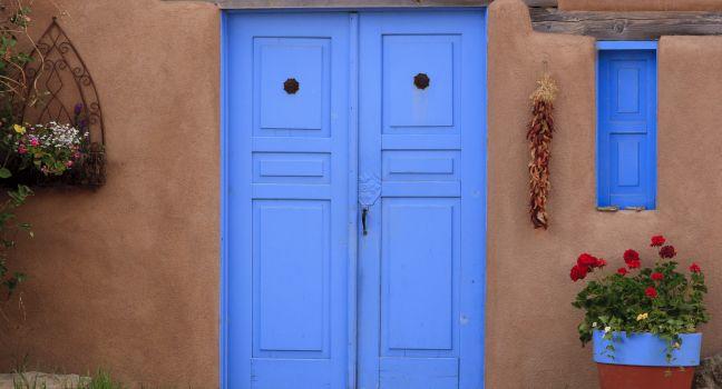 Adobe building and blue door in Rancho de Taos, NM