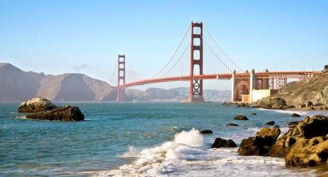 San Francisco Golden Gate Bridge from Baker Beach with pacific Ocean surf and waves.
