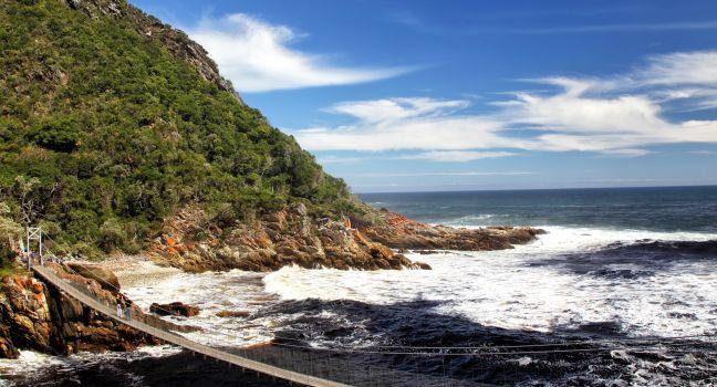 Suspension bridge over the river mouth of the Storms River in the Tistsikamma National Park, South Africa.